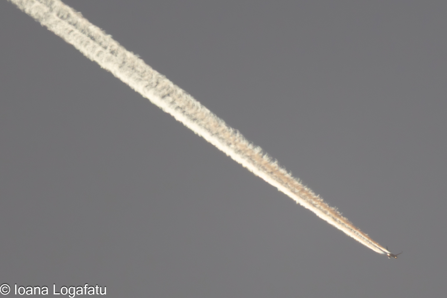 Jet trails carve paths through the open sky